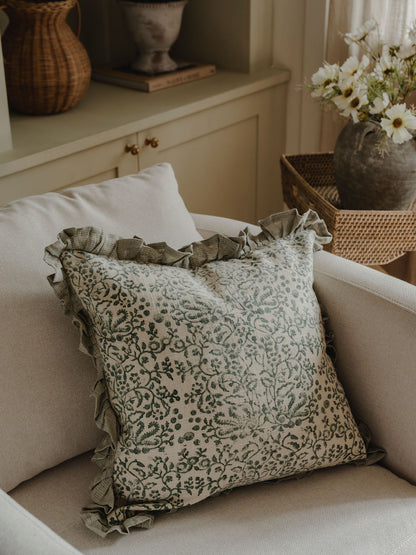 Decorative pillow with floral pattern on a beige sofa