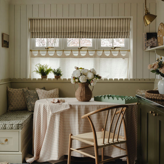 Nestled nook with a table, chairs, and decorative elements in a home setting.