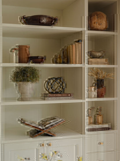 Ceramic pears styled on shelf with faux foliage and books
